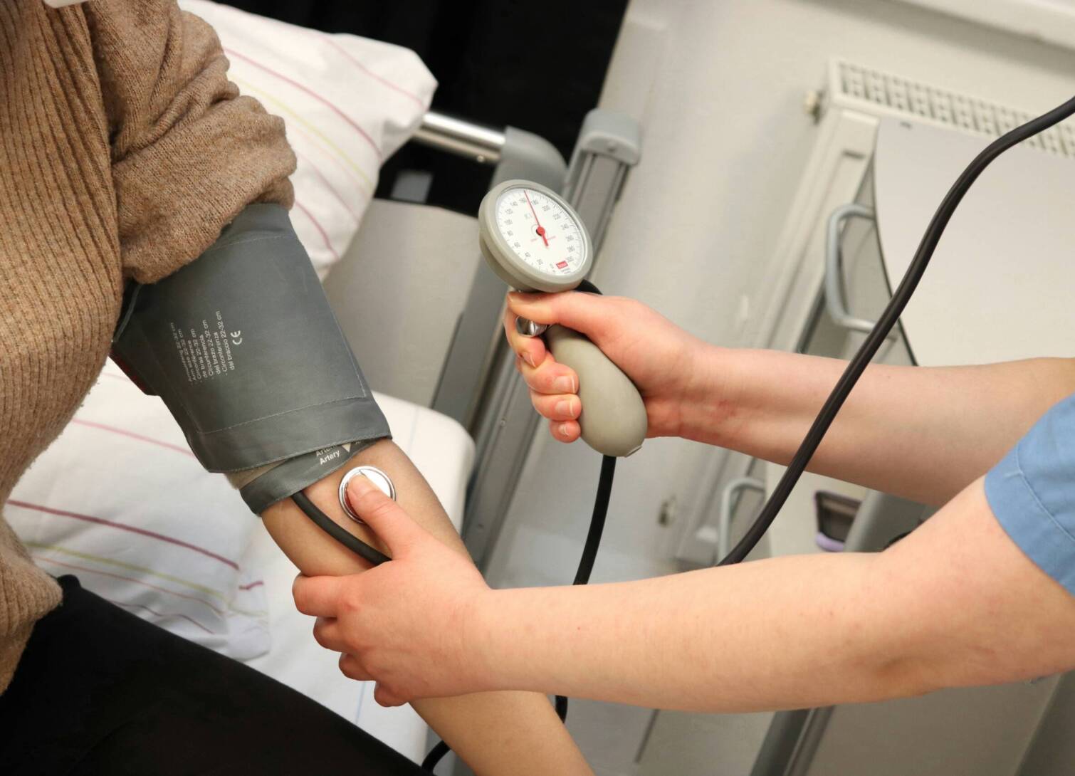 Nursing assistant taking blood pressure