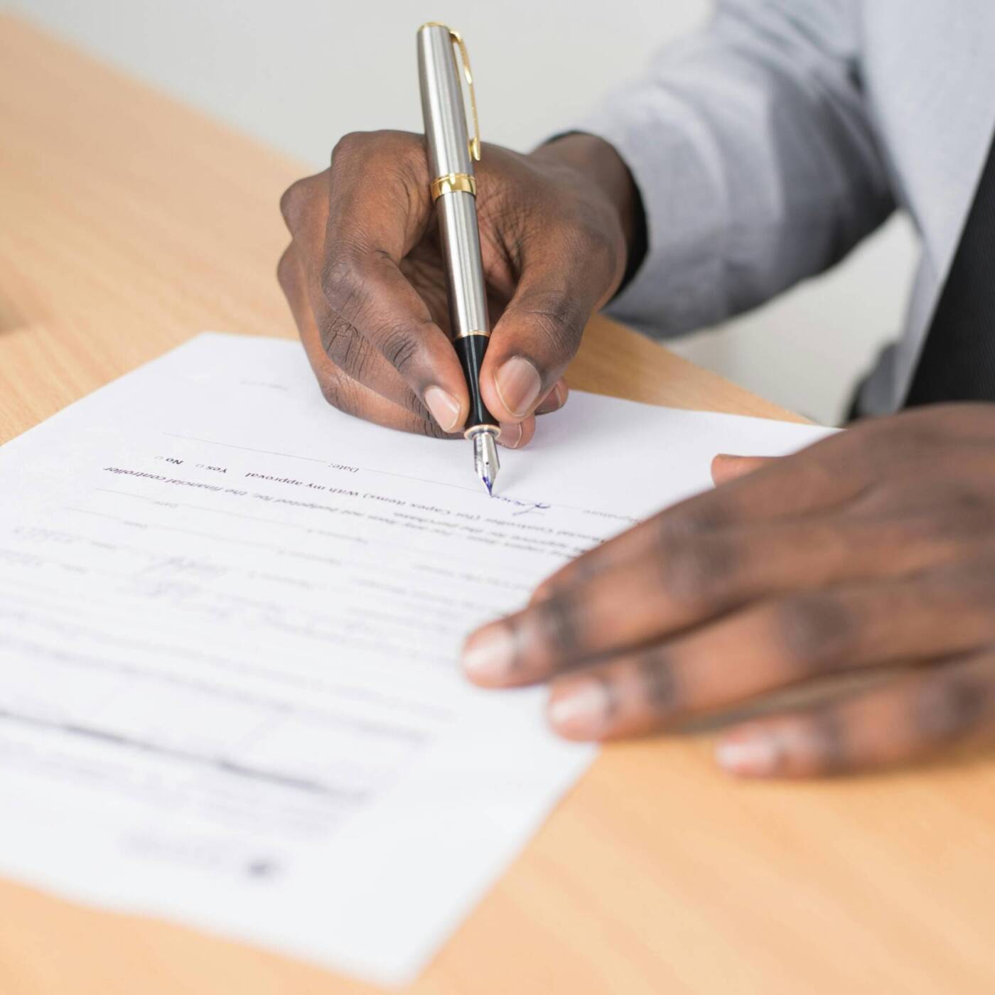 man signing document