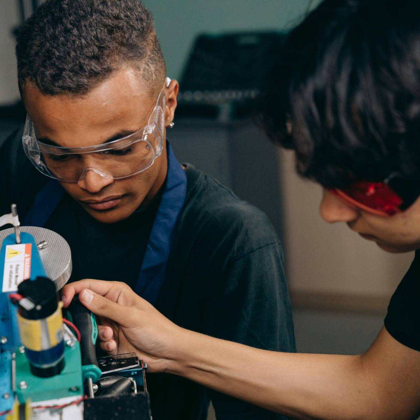 men assembling a robot