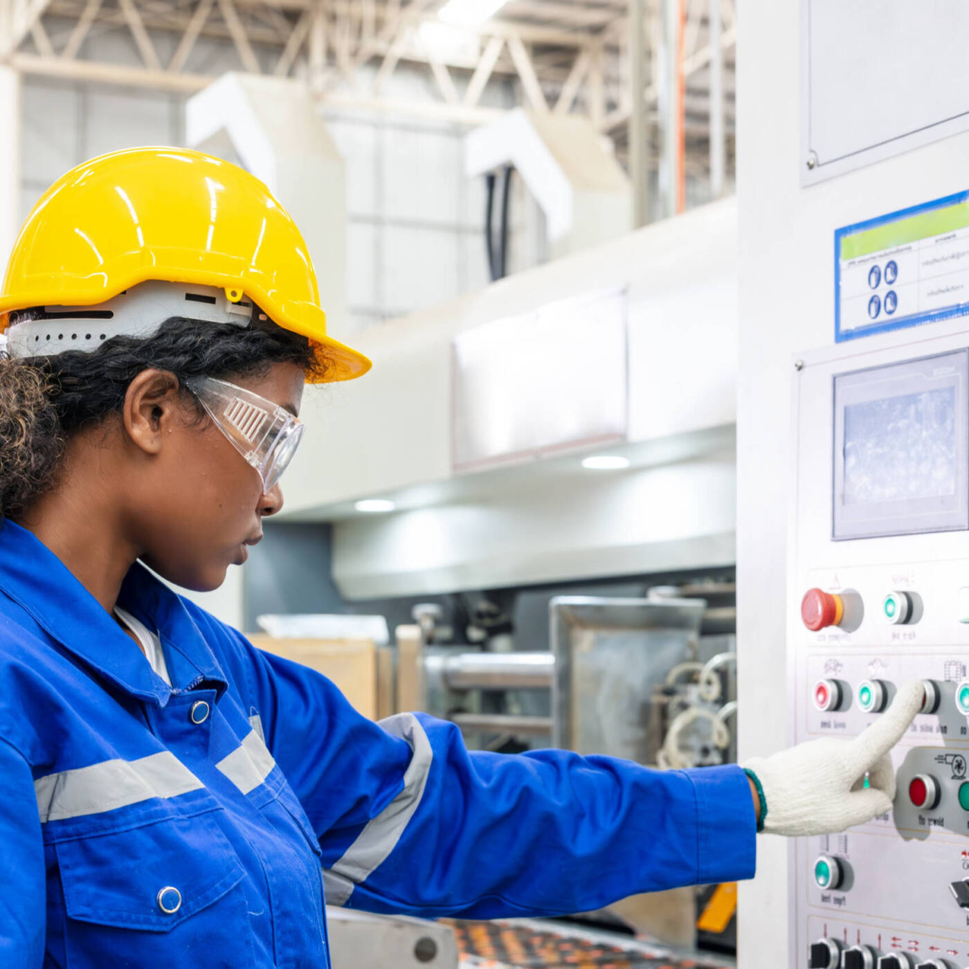 black female in industrial setting using high tech equipment