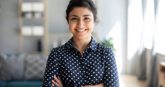 Smiling woman looking at camera with crossed arms